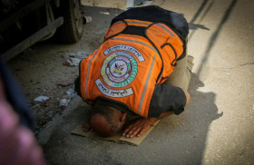 KEJAHATAN ISRALE - Petugas sedang sujud di tengah gempuran Israel ke Gaza, Palestina. Musa Alzanoun.